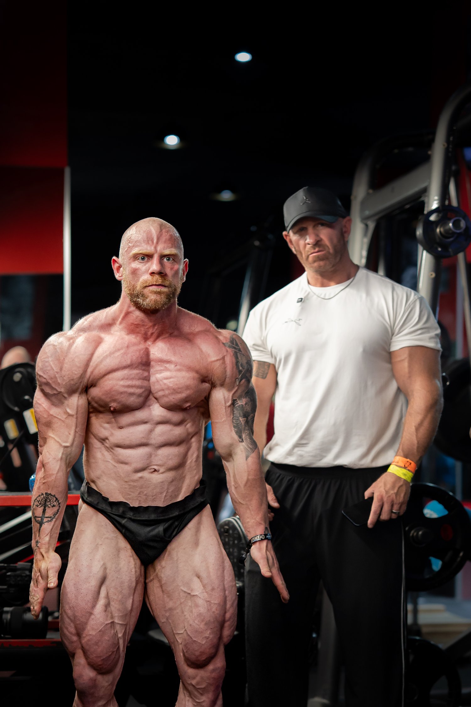 Bodybuilder with coach backstage