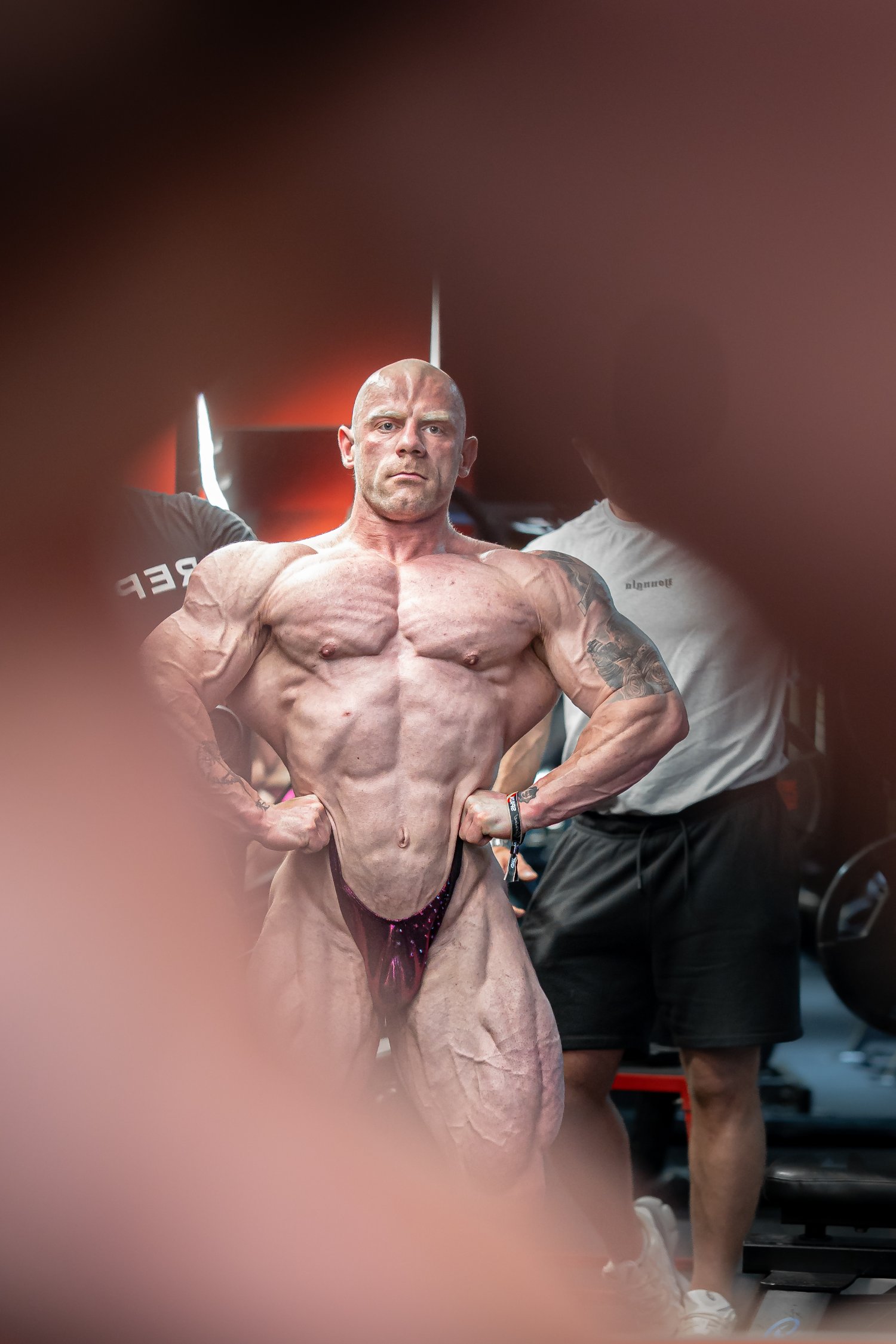 Bodybuilder posing in red light
