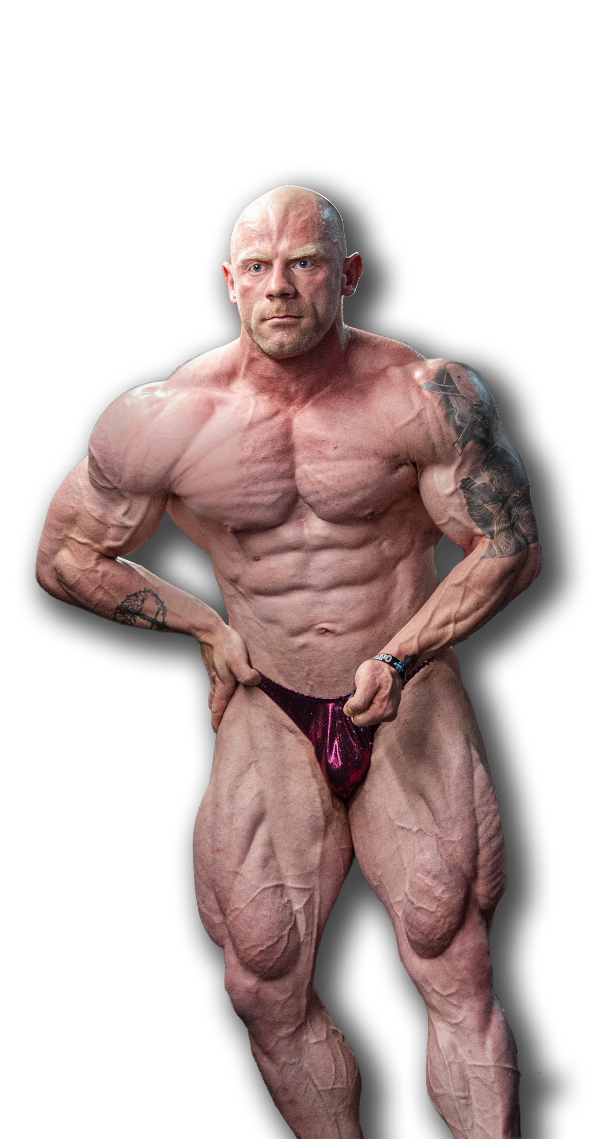 Competitive bodybuilder posing under stage light